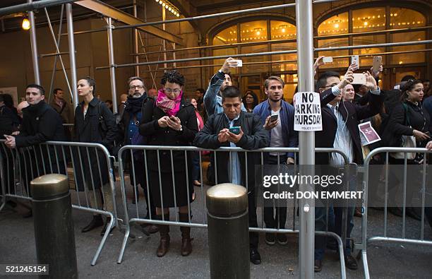 Commuters watch as protesters gather near Grand Central Station to protest against US Republican presidential candidate Donald Trump who was...