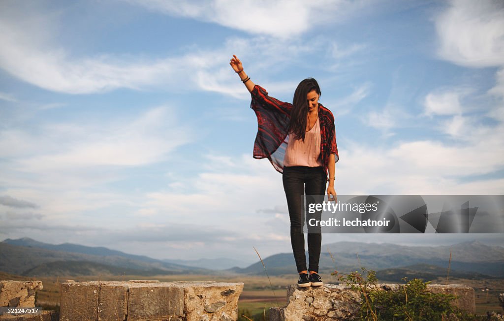 Young woman on the peak of a mountain range