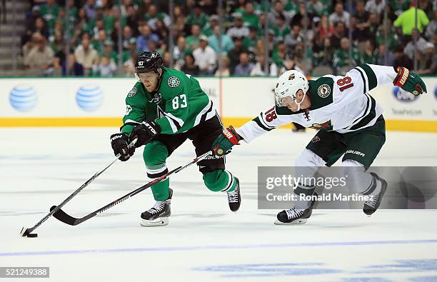 Ales Hemsky of the Dallas Stars skates the puck against Ryan Carter of the Minnesota Wild in the first period in Game One of the Western Conference...