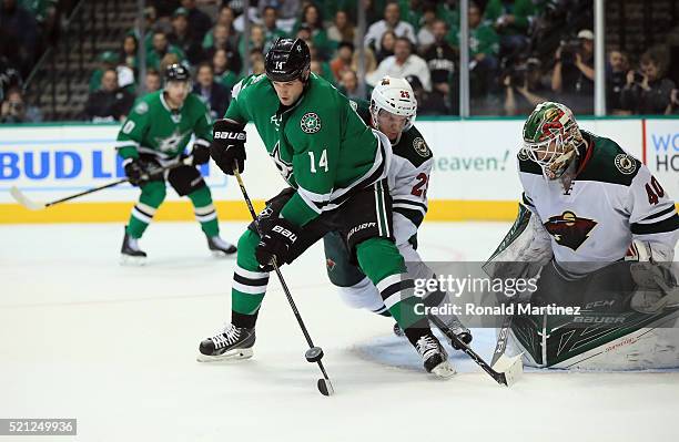 Jamie Benn of the Dallas Stars skates the puck in front of Devan Dubnyk of the Minnesota Wild in the first period in Game One of the Western...