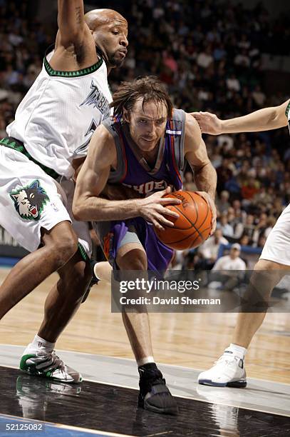 Steve Nash of the Phoenix Suns drives to the basket against Anthony Carter and Wally Szczerbiak of the Minnesota Timberwolves on February 2, 2005 at...