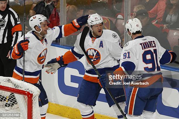 Kyle Okposo is congratulated by Frans Nielsen and John Tavares of the New York Islanders after scoring a third period goal against the Florida...