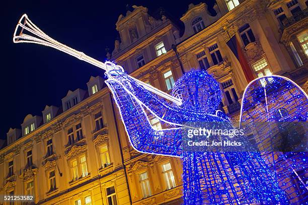 illuminated angel in old town square - prague christmas stock-fotos und bilder