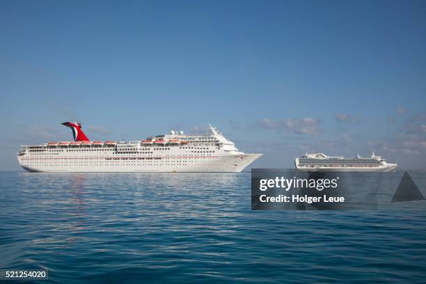 cruise ships carnival paradise (carnival cruise lines) and island princess (princess cruises) - princess cruises stock pictures, royalty-free photos & images
