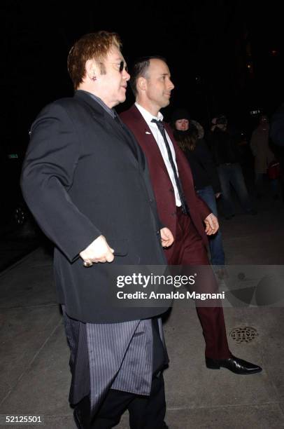 Singer Sir Elton John and David Furnish arrive at Sotheby's for an AmFar and ACRIA sponsored benefit to honor Herb Ritts February 2, 2005 in New York...