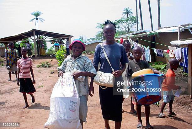 Liberian refugees Cecilia, Gekor, David and Davidettler Wilson leave a house of their tutor prior to boarding a ICRC car, 01 February 2005 in the...