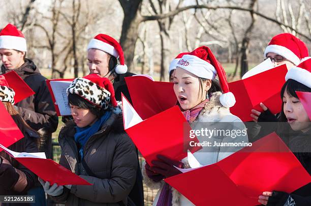 christmas carolers - carol singer stock pictures, royalty-free photos & images