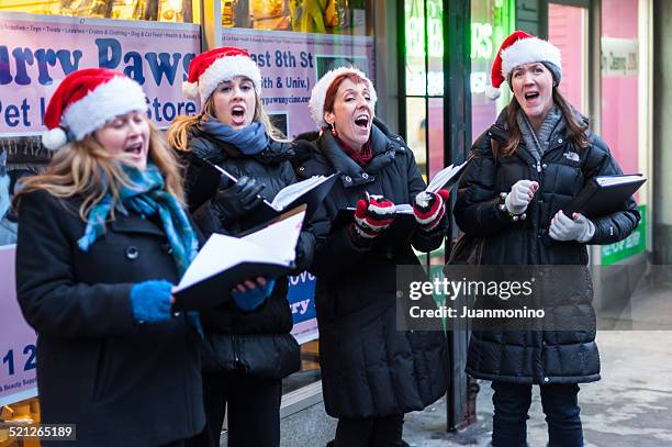 christmas carolers - carol singer stock pictures, royalty-free photos & images