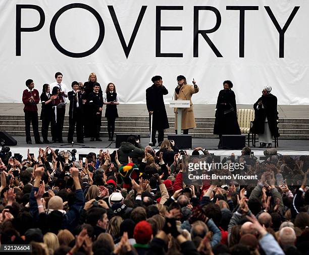 Former South African President Nelson Mandela and musician and campaigner Sir Bob Geldof are applauded by the crowd before making a speech endorsing...
