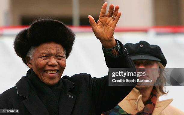 Former South African President Nelson Mandela waves to the crowd, watched by musician and campaigner Bob Geldof, before making a speech endorsing the...