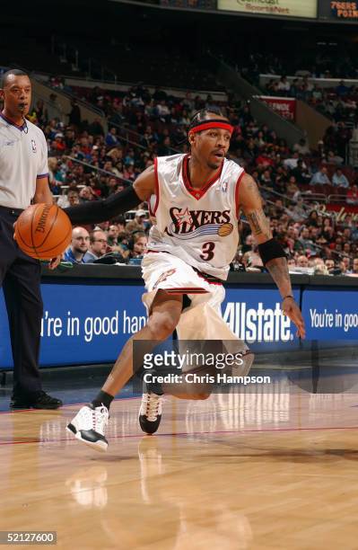 Allen Iverson of the Philadelphia 76ers dribbles the ball against the New Orleans Hornets as official Rodney Mott watches on January 17, 2005 at the...
