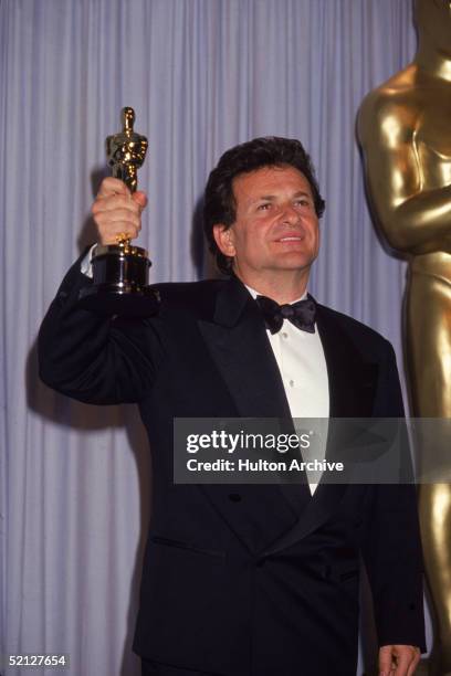 American actor Joe Pesci smiles as he holds up his Oscar for Best Supporting Actor for his role in 'Goodfellas' at the 63rd Annual Academy Awards...