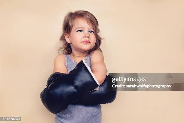 little girl with confident expression wearing boxing gloves - girl in tank top stock pictures, royalty-free photos & images