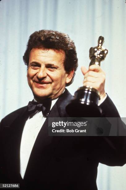 American actor Joe Pesci smiles as he holds up his Oscar for Best Supporting Actor for his role in 'Goodfellas' at the 63rd Annual Academy Awards...