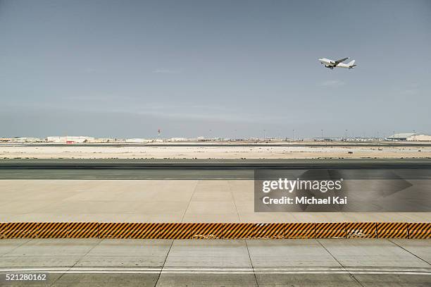 airport runway from side with departing airplane - doha airport stock pictures, royalty-free photos & images