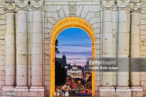 puerta de alcala at dusk - gran vía madrid stock pictures, royalty-free photos & images
