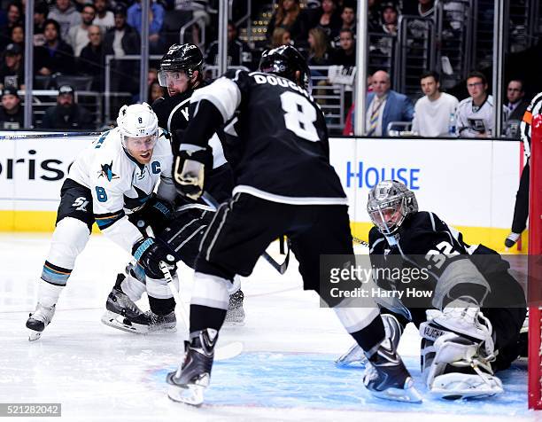 Joe Pavelski of the San Jose Sharks scores a goal past Jonathan Quick to take a 4-3 lead between Anze Kopitar and Drew Doughty during the third...
