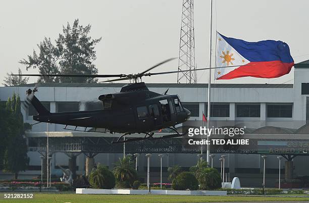 Philippine air force helicopter prepares to land next to a giant national flag, prior to the closing ceremony of the US-Philippines annual joint...