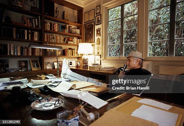 View of American television producer Norman Lear as he speaks in to a dictaphone in his home office, Los Angeles, California, November 1974.