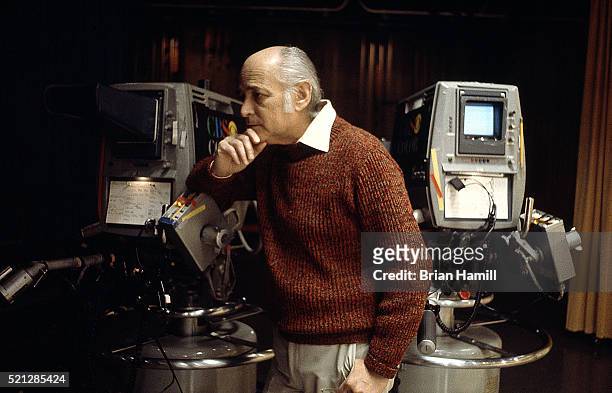 American television producer Norman Lear leans on a camera on the set of his tv show 'The Jeffersons' at CBS Studios, Los Angeles, California,...