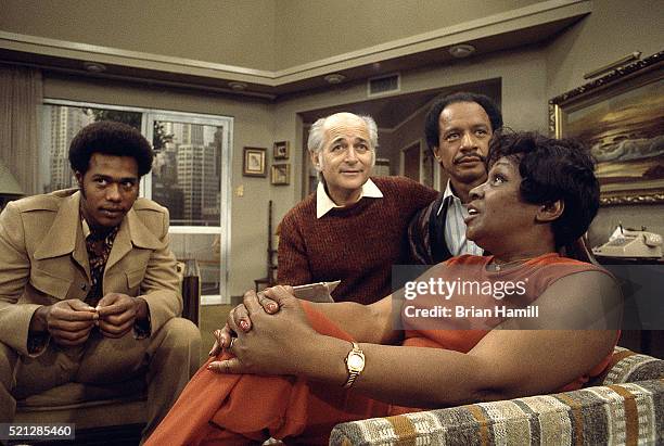 American television producer Norman Lear talks with actors Mike Evans Isabel Sanford , and Sherman Hemsley on the set of their tv show 'The...