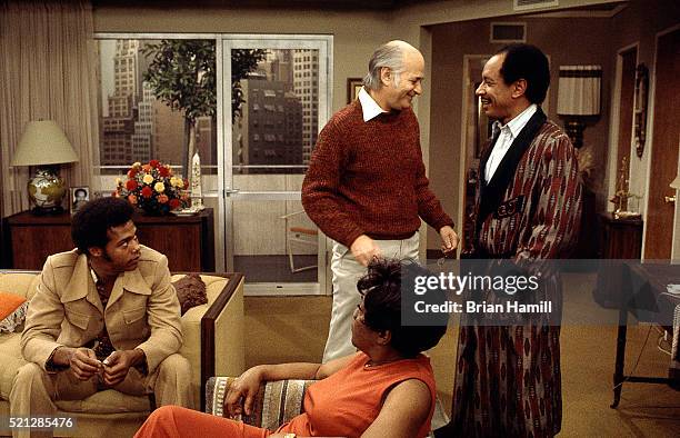 American television producer Norman Lear shares a laugh with actor Sherman Hemsley , watched by castmates Mike Evans and Isabel Sanford , on the set...