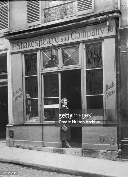 American publisher Sylvia Beach stands in the doorway of her bookshop Shakespeare & Company, Paris, France, 1920s. Famous for being run by the only...