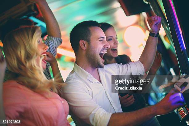group of people playing slots. - casino stock pictures, royalty-free photos & images