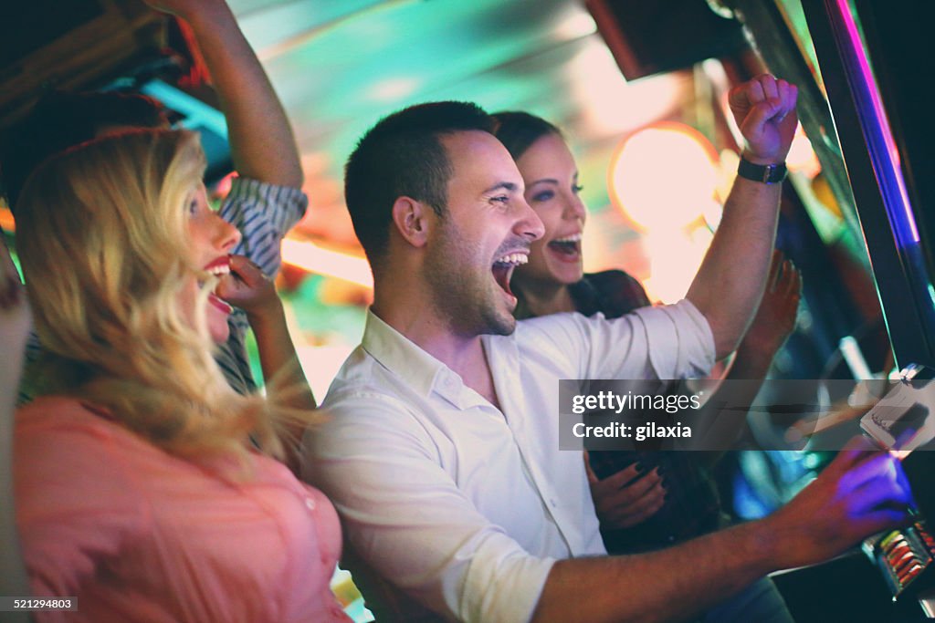 Group of people playing slots.