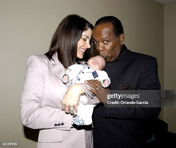 Singer Lou Rawls kisses his baby, Aiden Allen Rawls, as he and his wife, Nina Malek Inman, attend the inaugural event of the Lou Rawls Center For The...