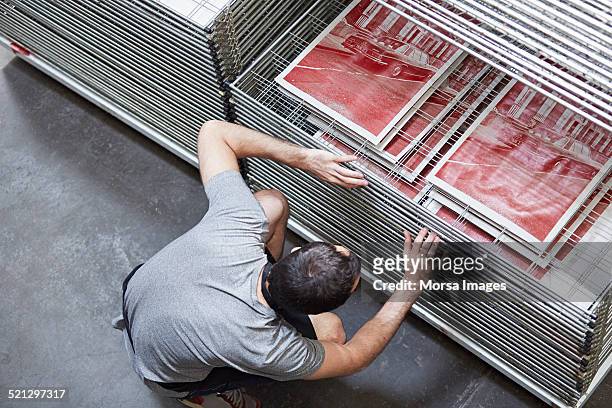 silk screen worker inspecting prints - silk screen stock pictures, royalty-free photos & images