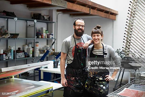 couple of silk screen workers at their workshop - small business imagens e fotografias de stock