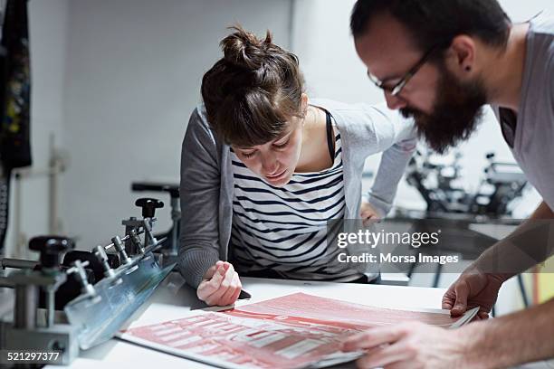 copule inspecting the printing results - designer profissional - fotografias e filmes do acervo