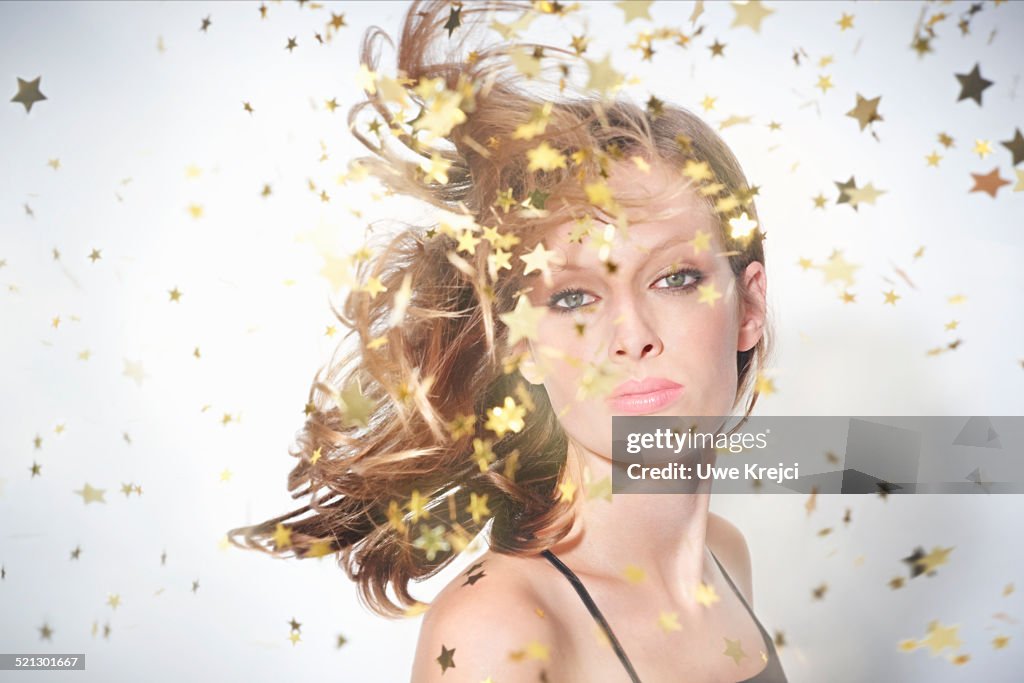 Young woman surrounded by sparkling stars