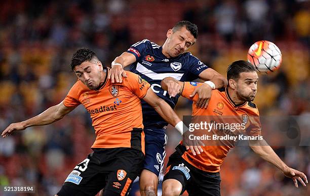 Dimitri Petratos and Jack Hingert of the Roar compete for the ball against Daniel Georgievski of the Victory during the A-League Elimination Final...