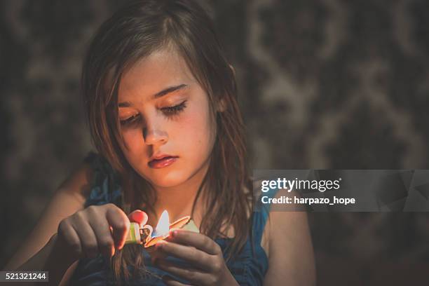 girl holding a candle - blackout stock-fotos und bilder