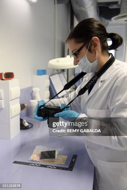 Forensics police officer, part of the Services Regionaux d'Identite Judiciaire , takes a picture at the central police station in Toulouse on April...