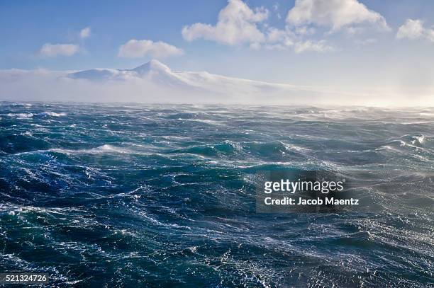 rough water on the bering sea - alaska mountains stockfoto's en -beelden