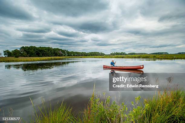 a man on the river - seniors canoeing stock pictures, royalty-free photos & images