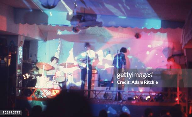 Psychedelic light show surrounds Nick Mason, Roger Waters, Syd Barrett and Rick Wright of Pink Floyd as they perform at the UFO Club, London, 23rd...