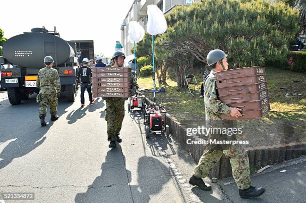 Japan Self-Defense Forces carry relief supplies a day after the 2016 Kumamoto Earthquake at the Mashiki Town Hall on April 15, 2016 in Mashiki,...