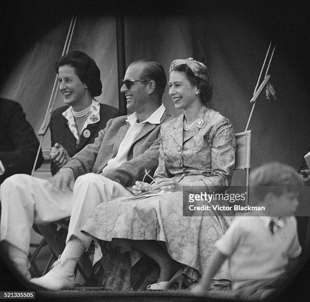 Queen Elizabeth II and Prince Philip, Duke of Edinburgh watch a cricket match at Highclere Castle, Highclere, Hampshire, 3rd August 1958.