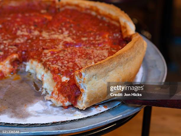 a chicago-style deep-dish pizza. - deep dish pizza stock pictures, royalty-free photos & images