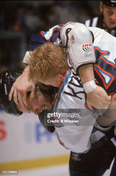 Canadian pro hockey players Shawn Antoski of the Mighty Ducks and Paul Kruse of the NY Islanders fight on the ice at Nassau Coliseum, Uniondale, New...