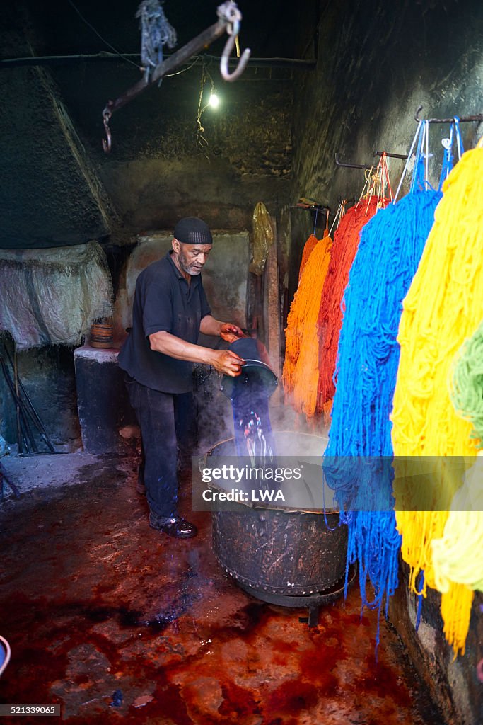 Man working with dyes in tannery