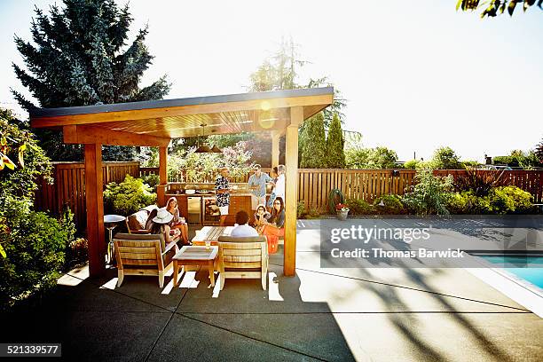 group of friends and family relaxing under cabana - cabana stock pictures, royalty-free photos & images