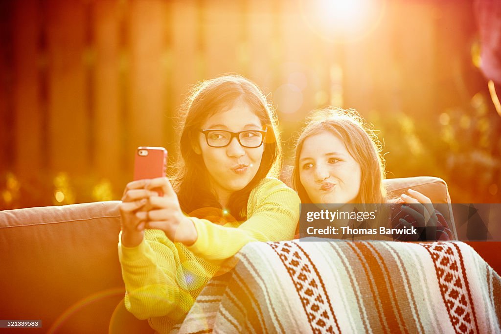 Two girls taking self portrait with smartphone