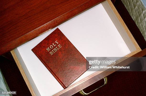 gideon bible in hotel drawer - bible stock pictures, royalty-free photos & images