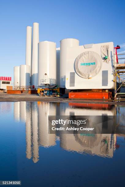 wind turbine parts for the walney offshore wind farm on the dock side at mostyn in north wales. - siemens stock pictures, royalty-free photos & images