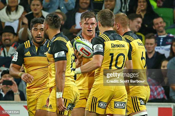 Jason Woodward of the Hurricanes is congratulated his teammates after scoring a try during the round eight Super Rugby match between the Rebels and...